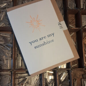 Greetings Card letterpress printed in blue and yellow, with the the words You Are My Sunshine