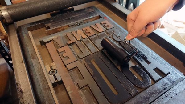 Print a Poster framed inking up the wooden type