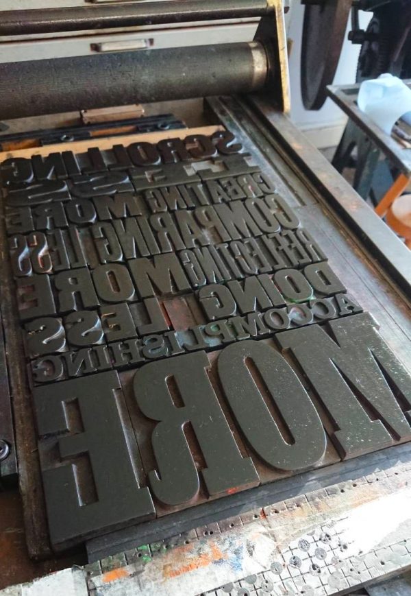 Scrolling Less Letterpress Poster with Holly Tucker print on the press