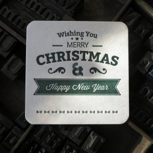 Letterpress Christmas Coaster. Hand printed in green on a vintage letterpress machine.
