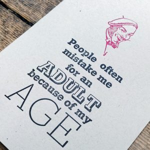 People often mistake me for an adult because of my age. - Letterpress Card. Hand printed in bright red and black, using original letterpress type.